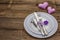 Romantic table setting on vintage wooden boards background. Valentine`s day or Wedding card template. Lilac felt heart, lavender,