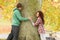 Romantic Teenage Couple By Tree In Autumn Park