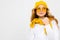 Romantic teenager girl with yellow retro glasses and with a yellow hat and scarf on an isolated white background with