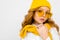 Romantic teenager girl with yellow retro glasses and with a yellow hat and scarf on an isolated white background with