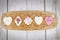 Romantic-themed cookies displayed on a wooden board.