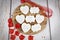 Romantic-themed wedding cookies displayed on a wooden board.