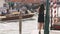 Romantic tourist woman on pier against beautiful view on venetian chanal in Venice, Italy.