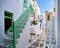 Romantic traditional narrow alleyways of Greek island towns. White houses, flower pots, colorful balconies and doors