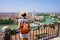 Romantic traveler girl visiting Verona city of love. Back view of young female backpacker enjoying cityscape of Verona, Italy