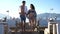 Romantic trip, joyful couple running together on jetty against beautiful sea landscape