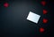 Romantic valentine mock up with white   note or card  on black background with red  hearts  for your message ,copy space