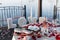 Romantic Valentine`s Day dinner setup with rose petals