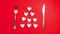 Romantic valentines day dinner idea concept. Heart on plate and silver wear on red background. Stop motion animation