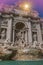 Romantic view of Trevi fountain at sunset in Rome