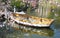 Romantic view of a wooden boat in Copenhagen in Denmark surrounded by a sea of â€‹â€‹flowers in a small lake