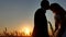 Romantic wedding kiss young couple silhouette. Loving couple at sunset nature man and girl silhouette