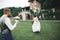 Romantic wedding moment, bride running from groom in a park