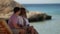 romantic weekend on seashore in summer vacation, young man and woman are embracing