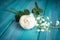 Romantic white bouquet with rose tree and lilly of the valley flowers, teal wooden background.