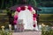 Romantic white wedding aisle archway with rose petals, flowers a