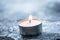 Romantic Winter Tea Light On Cracked Ice Above A Wooden Floorboard