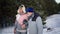 romantic winter walk in woods, gray-haired spouses spend time together walking outdoors in forest