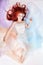 Romantic woman with long hair and cloud dress. Girl dreaming bright makeup and perfect body. Redhead girl in light airy colored
