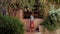 Romantic woman in red dress looking to showcase or shop window of old traditional bakery shop in old town Antibes