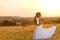 Romantic woman in sunset corn field wear dress