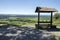 Romantic wooden tourists shelter with seats and table on viewpoint, beautiful landscape, Stremosice