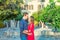 Romantic young couple in bright red and blue clothes embracing on the mediterranean city street. Love, dating, romance. Lifestyle