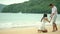 Romantic young couple draw heart shapes in the sand on the beach.