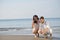 Romantic young couple draw heart shapes in the sand while on honeymoon. summer beach love concept.