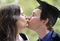 Romantic young couple kissing after man graduates university