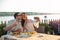 Romantic young couple posing for a selfie, eating dinner in a riverside restaurant