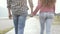 Romantic young couple walking and holding hands