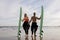 Romantic Young Surfers Couple Posing Together On The Beach In Summer Time