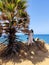 A romantic young women stands and poses on the edge of the island `s land, a cape. The having a rest tourist on the Andamand sea.