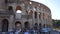 Rome, Italy - 5 September 2023. Crowd of sightseeing tourists walking by facade Roman Colosseum. One of most famous