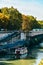 Rome,Italy - circa 2019: Discover the charms of Rome by navigating the Tiber River. Boat leaving dock to sail on canal.