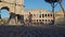 Rome, Italy - December 13th 2020: View of the Arch of Constantine and Coliseum with few tourists