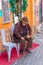 Rome, Italy - December 17, 2019: Elderly senior Italian man in street cafe in historic city