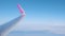 Rome, Italy - February 14, 2020: Wizzair plane wing in air against blue sky and white clouds. New route opening