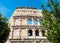 ROME, Italy: Great Roman Colosseum Coliseum, Colosseo also known as the Flavian Amphitheatre, with Green Trees. Famous world lan
