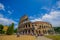 ROME, ITALY - JUNE 13, 2015: Roman coliseum view from outside, turists walking and visiting this iconic structure