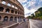 ROME, ITALY - JUNE 2014: Tourists visit Colosseum. The city attracts 15 million people annually