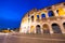 ROME, ITALY - JUNE 2014: Tourists visit Colosseum at night. The city attracts 15 million people annually