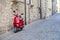 Rome, Italy - March 31, 2019: Red Scooter Vespa parked on old street.