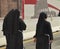 Rome, Italy-October 07, 2018, three nuns dressed in black robes walking the streets of Rome, the view from the back