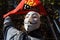 Rome, Italy - October 18, 2019: The mask of Anonymous in front of the flag of Asia USB during the garrison in front of the