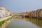 Rome, Italy - A panoramic view of the Ponte Vecchio and the Arno river reflecting the buildings in its water during a cloudy