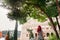 Rome, Italy - A redhead young adult brazilian woman in her 20s looking into the Colosseum taken in a park during the afternoon