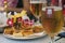 Rome, Italy - September 16 2019: Glasses of beer and small pizzetas as apperizer. Appetizers and Snacks decorated with european