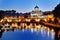 Rome, Italy - view of the Tiber river and St. Peter\'s Basilica at night